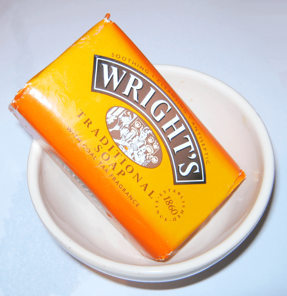 A bowl holding a bar of Wright's Traditional Soap in its wrapper