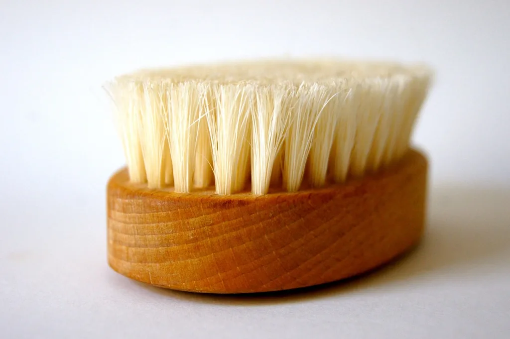 Bath brush to scrub feet during a home pedicure.