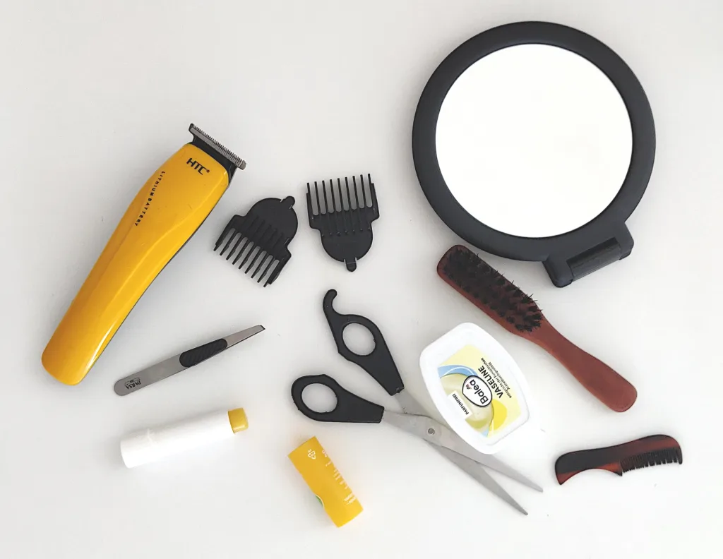 A selection of items needed to trim a man's eyebrows.