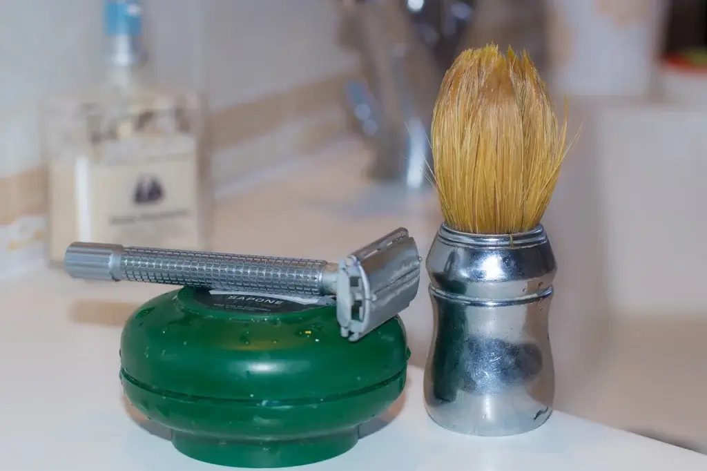 Men's shaving equipment: a razor, shaving soap and a shaving brush.