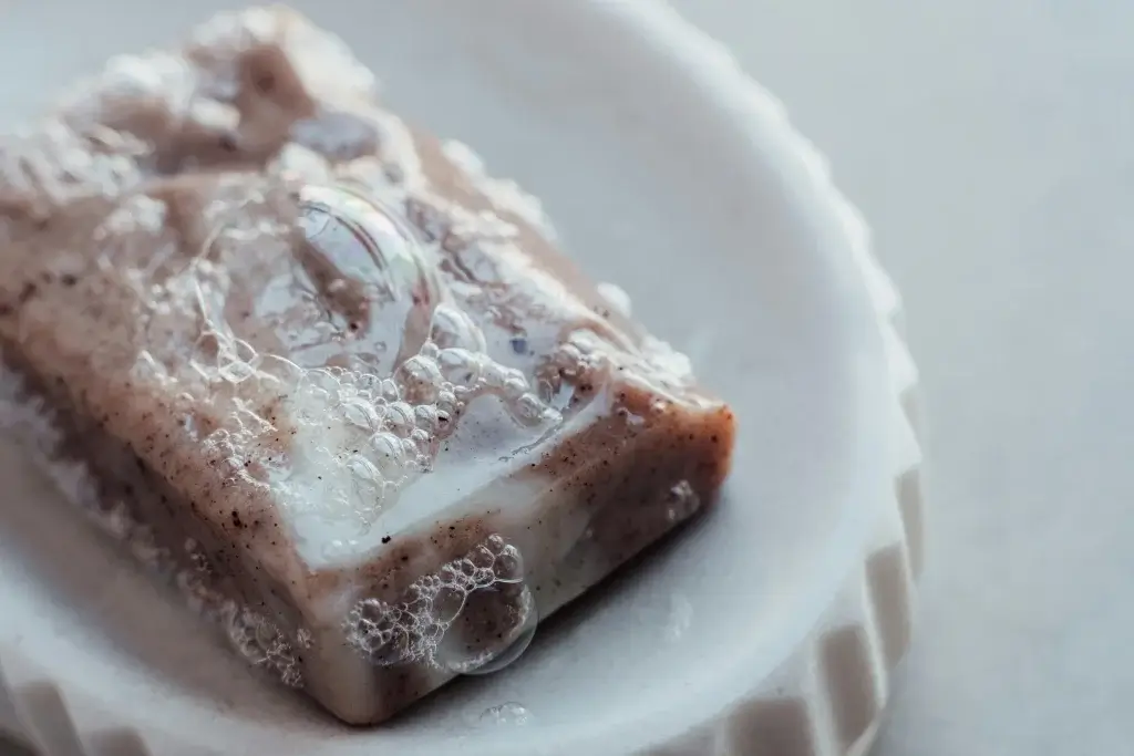 A freshly used bar of soap in a soap dish.