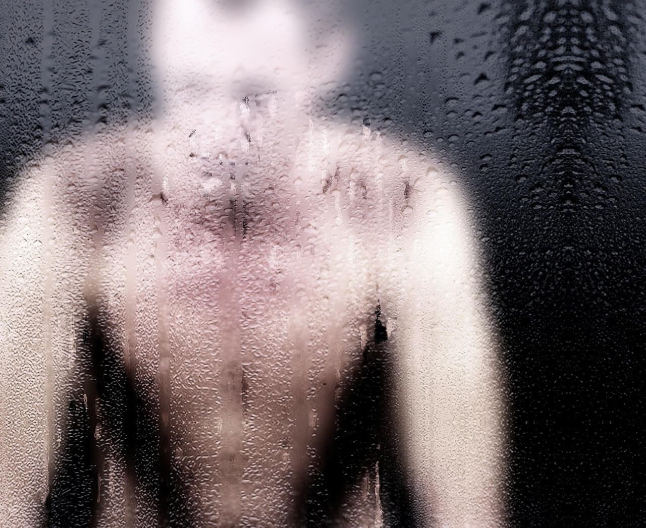 Man behind fogged glass in a shower setting, symbolizing the emotional impact of "old people smell" and the struggle to get rid of it.