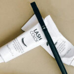 Eyelash tinting for men: two tubes of lash color cream with applicator brush for home use.