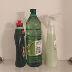 Dish soap, white vinegar, and a vinegar and dish soap mixture in a spray bottle.