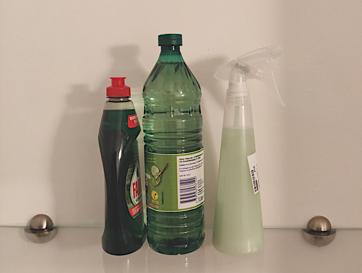 Dish soap, white vinegar, and a vinegar and dish soap mixture in a spray bottle.