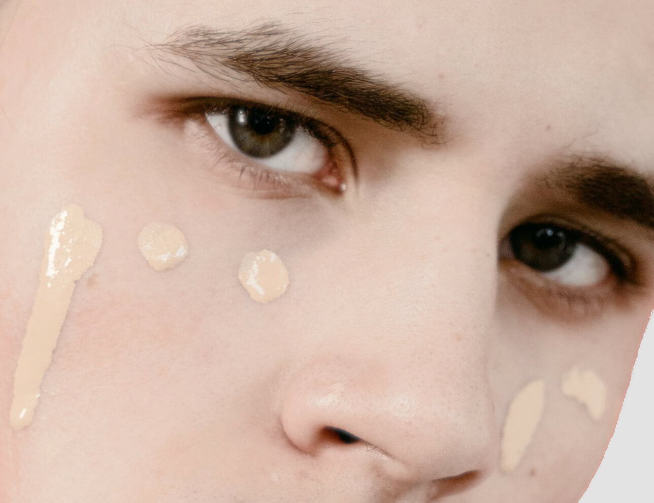 Man wearing unblended tinted moisturizer on his face.