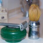 Traditional wet‑shaving tools—a safety razor, brush and soap—on a bathroom counter, for an effective shave morning or evening.
