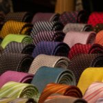 A drawer of rolled ties in various colors and patterns, demonstrating how to store and care for ties.