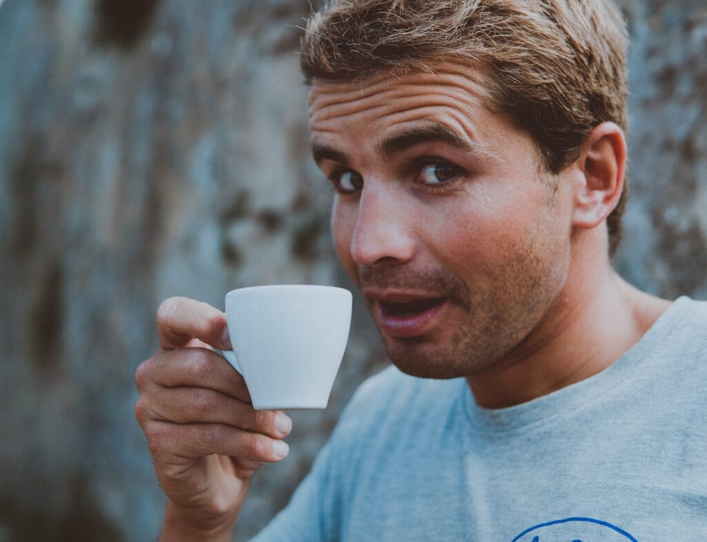 A man holding an espresso.