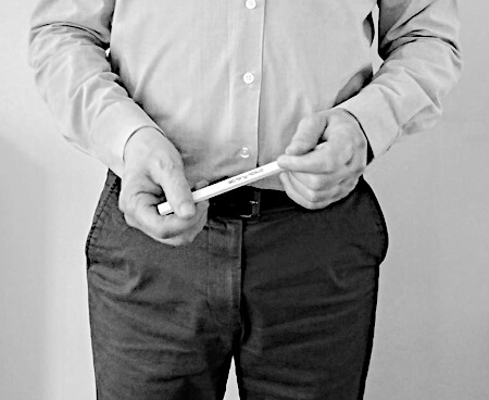 Man using a pencil as a prop to occupy his hands while giving a talk.
