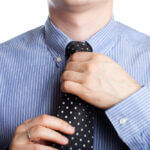 Man adjusting his tie.