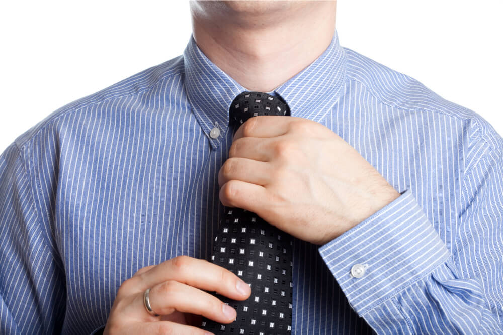 Man adjusting his tie.