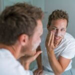A man applying an exfoliant.