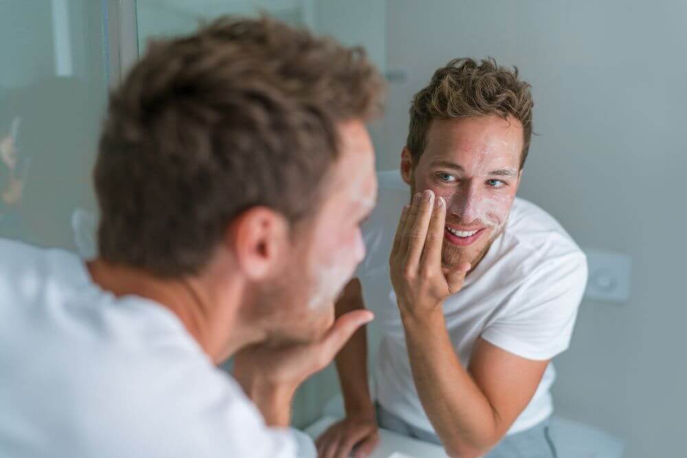 A man applying an exfoliant.
