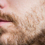 Close up of a patchy full beard.